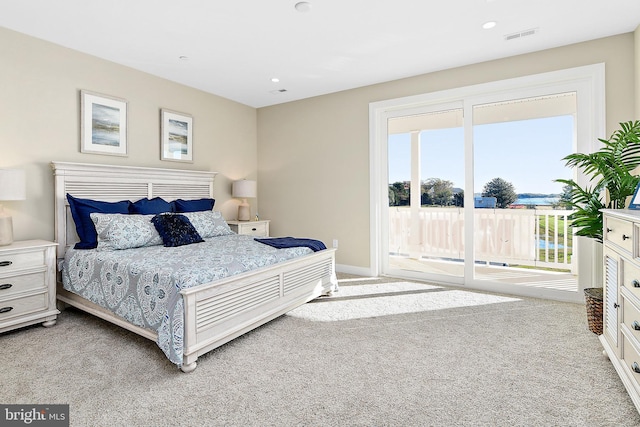 bedroom with access to exterior, recessed lighting, visible vents, light carpet, and baseboards