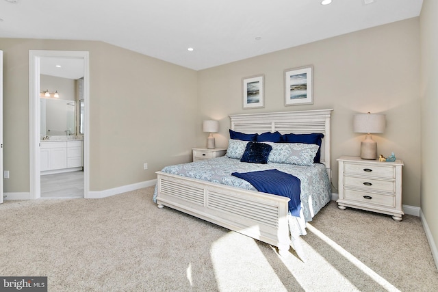 carpeted bedroom featuring recessed lighting, baseboards, and ensuite bathroom