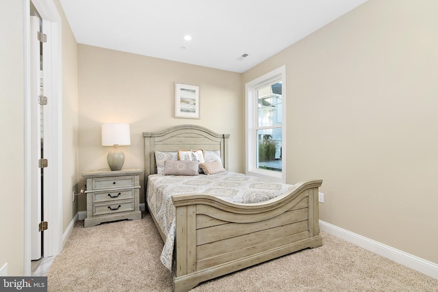 carpeted bedroom with visible vents and baseboards