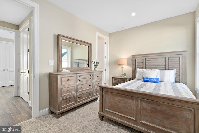 bedroom with wood finished floors and baseboards