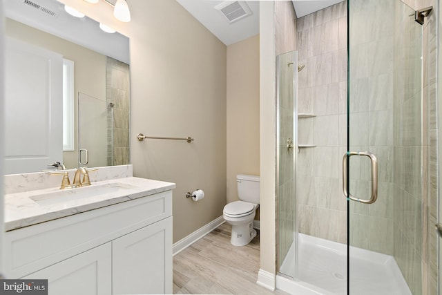 bathroom featuring a stall shower, visible vents, vanity, and toilet