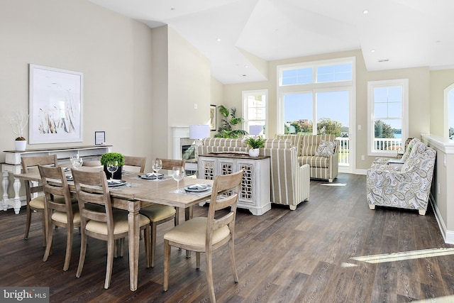 dining room with dark wood-style floors, recessed lighting, a fireplace, and baseboards