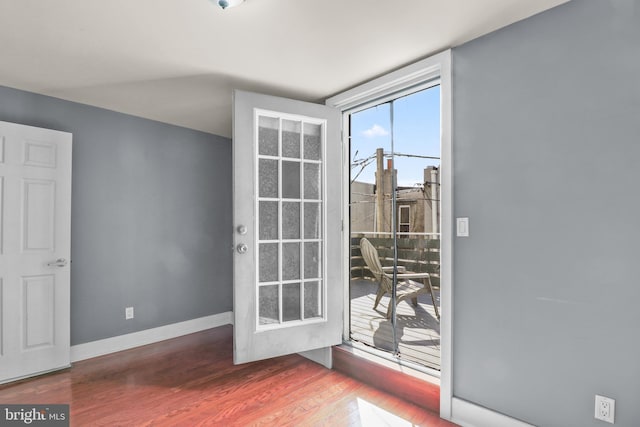 entryway with wood finished floors and baseboards