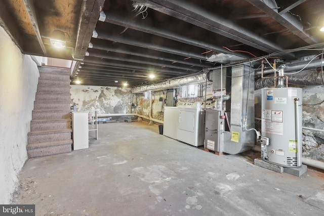 unfinished basement featuring heating unit, washing machine and dryer, stairs, and gas water heater