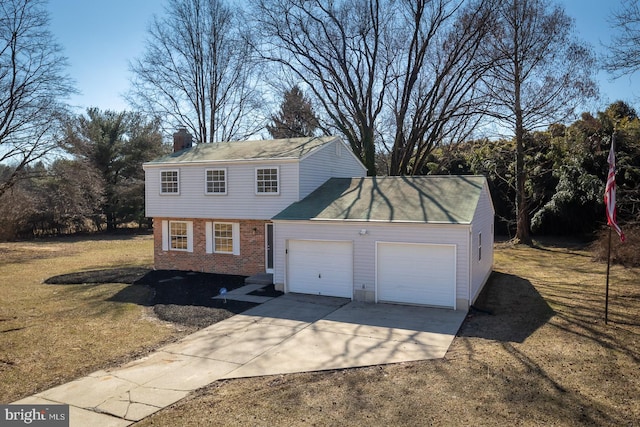 view of front of home with driveway, brick siding, a chimney, and an attached garage