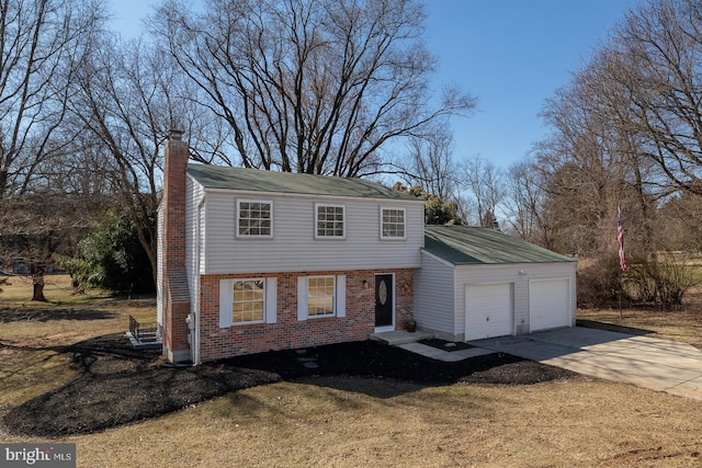 colonial house featuring a garage, brick siding, concrete driveway, a front lawn, and a chimney