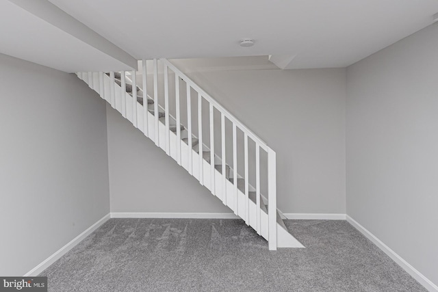 stairway with carpet and baseboards