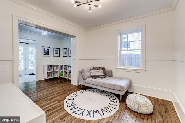 living area with a wealth of natural light, crown molding, and wood finished floors