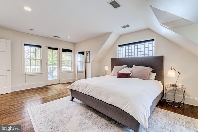 bedroom featuring access to exterior, baseboards, visible vents, and wood finished floors