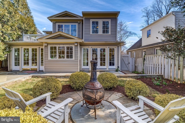 back of house featuring an outdoor fire pit, a patio, a gate, fence, and french doors