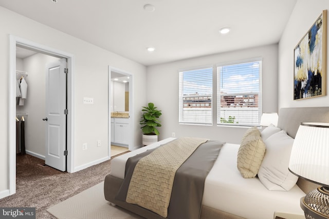 bedroom featuring recessed lighting, baseboards, a spacious closet, carpet, and ensuite bath