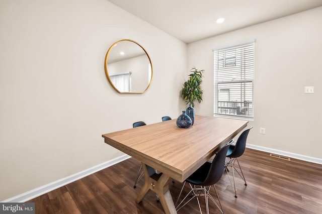 dining room featuring baseboards, wood finished floors, and recessed lighting