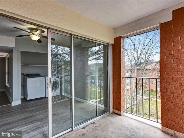 balcony with washing machine and clothes dryer