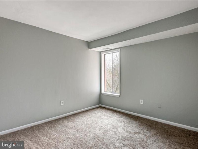 empty room with visible vents, baseboards, and carpet flooring