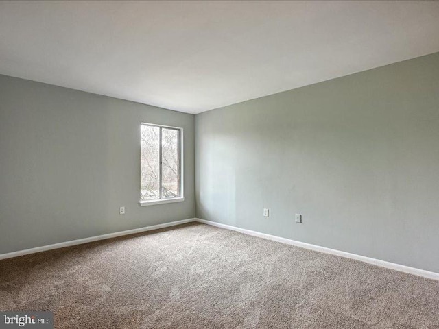 empty room with carpet floors and baseboards