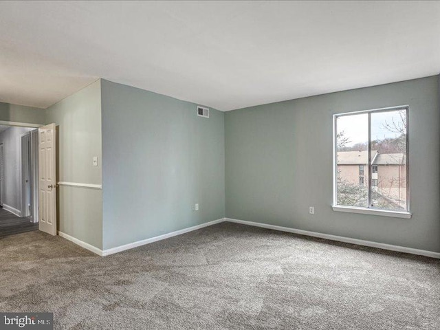 carpeted empty room with baseboards and visible vents