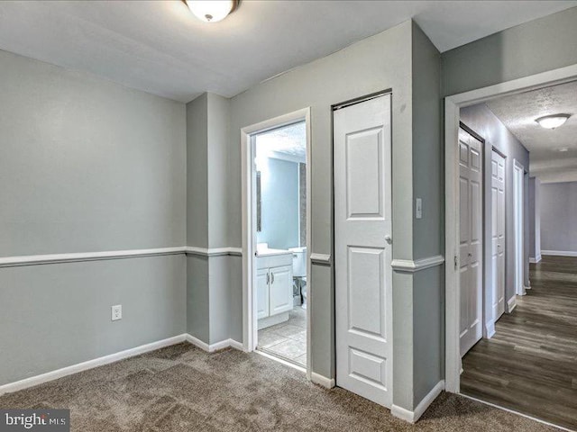 hall featuring carpet floors and baseboards