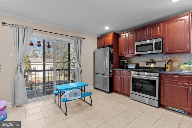 kitchen featuring crown molding, appliances with stainless steel finishes, baseboards, and tasteful backsplash