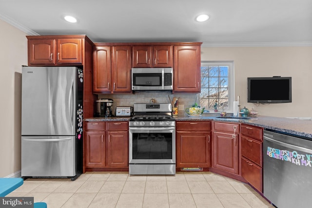 kitchen with light tile patterned floors, decorative backsplash, appliances with stainless steel finishes, ornamental molding, and a sink