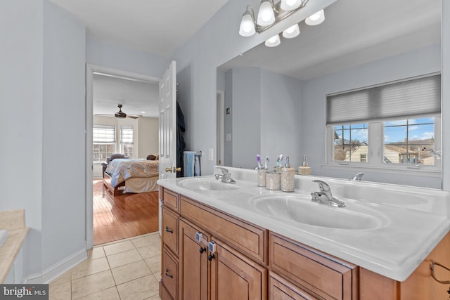 full bath with double vanity, tile patterned flooring, a sink, and ensuite bathroom