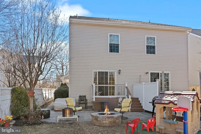 rear view of house featuring a patio, an outdoor fire pit, and fence