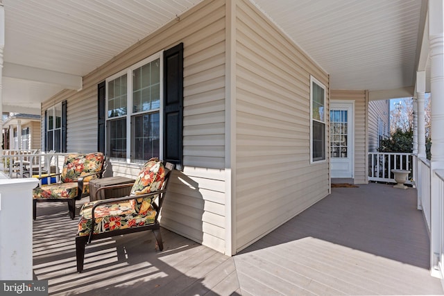 wooden terrace with a porch