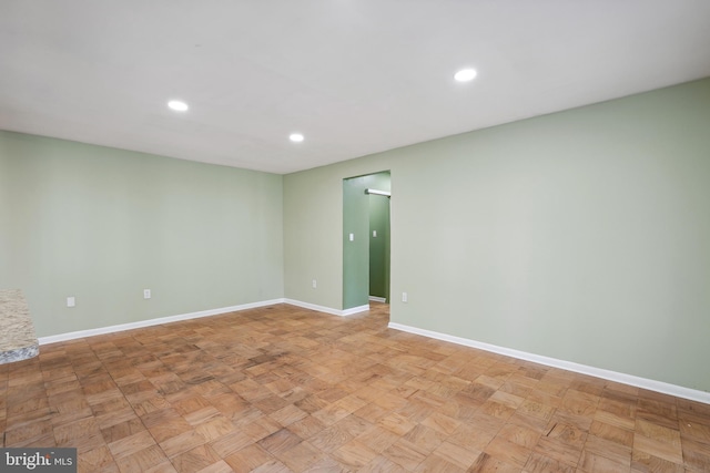 spare room with baseboards and recessed lighting