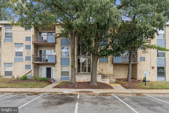 view of building exterior featuring uncovered parking