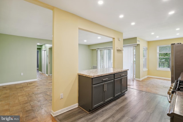 kitchen with recessed lighting, freestanding refrigerator, and baseboards