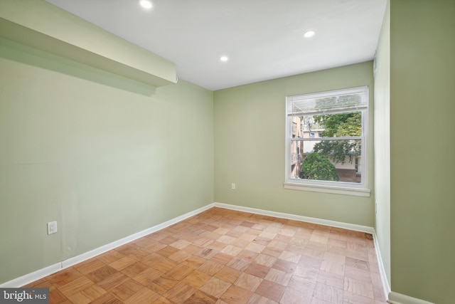 unfurnished room featuring recessed lighting and baseboards