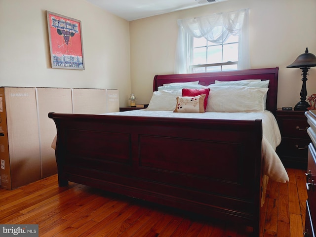 bedroom with wood finished floors and visible vents