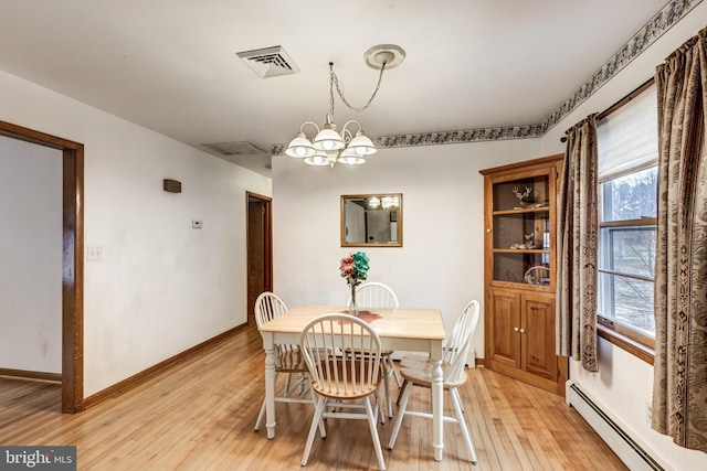 dining area featuring visible vents, an inviting chandelier, light wood finished floors, baseboards, and baseboard heating