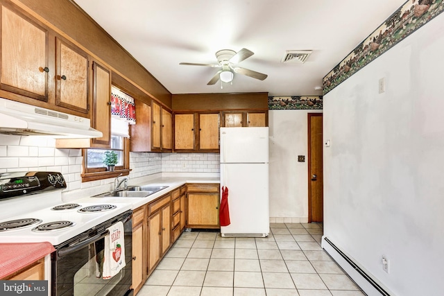 kitchen with visible vents, under cabinet range hood, range with electric stovetop, freestanding refrigerator, and baseboard heating