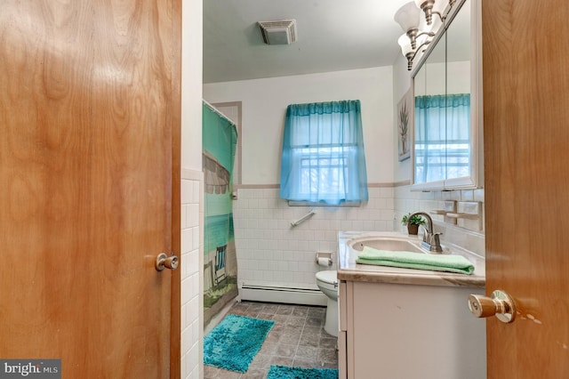 full bath with visible vents, toilet, tile walls, a baseboard radiator, and vanity