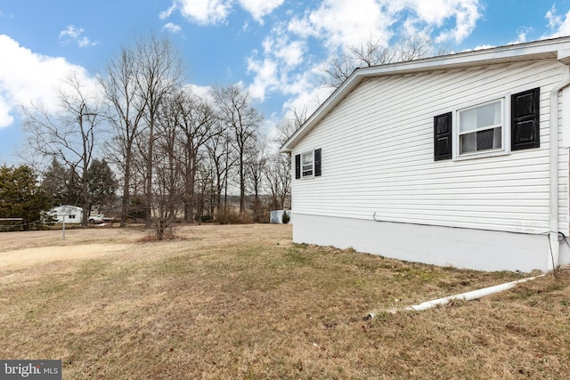 view of property exterior with a lawn