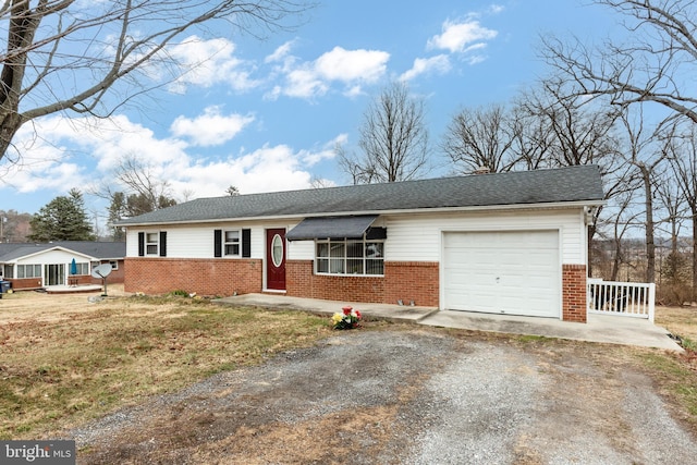 ranch-style home with a garage, brick siding, roof with shingles, and driveway