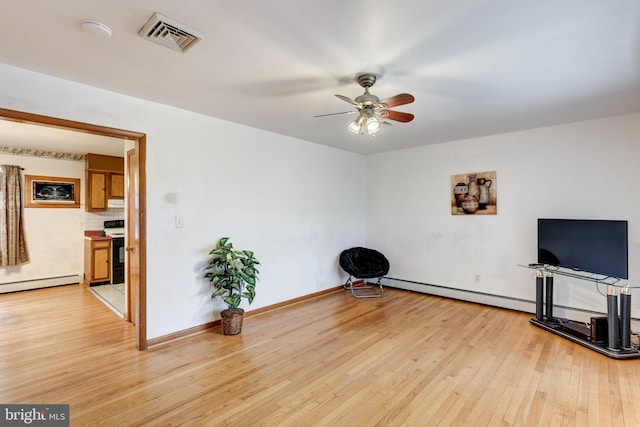 unfurnished room with visible vents, a ceiling fan, a baseboard heating unit, light wood-style floors, and baseboards