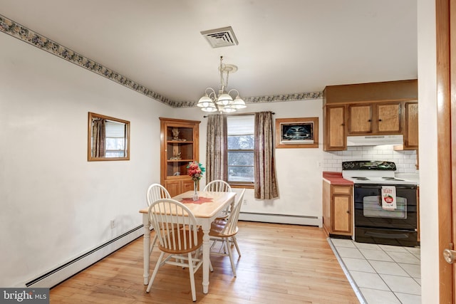 dining space featuring baseboard heating, an inviting chandelier, light wood-style flooring, and visible vents