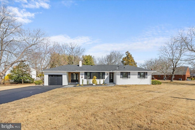 single story home featuring a garage, a front yard, driveway, and a chimney