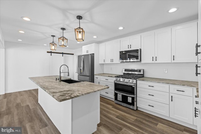 kitchen with appliances with stainless steel finishes, white cabinets, dark wood-type flooring, and a sink