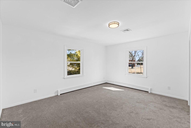 carpeted empty room with a baseboard radiator, visible vents, and baseboards