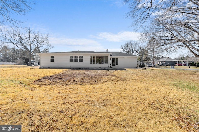 rear view of property with a yard and crawl space