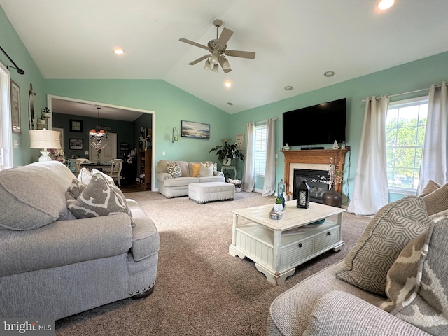 living area featuring carpet, lofted ceiling, recessed lighting, a glass covered fireplace, and ceiling fan