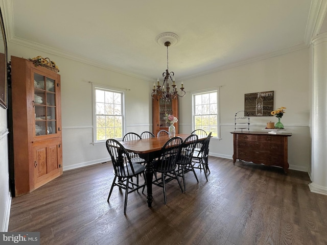 dining area with an inviting chandelier, baseboards, ornamental molding, and dark wood finished floors