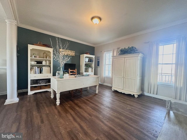 unfurnished office featuring baseboards, decorative columns, ornamental molding, and wood finished floors