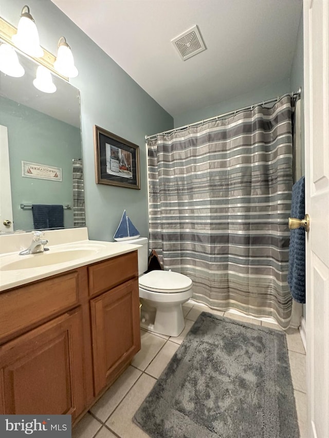 bathroom with curtained shower, toilet, vanity, visible vents, and tile patterned floors