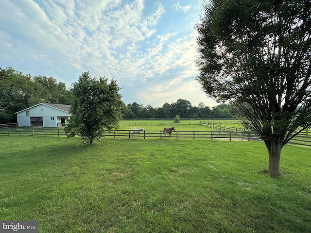 view of yard featuring fence and a rural view