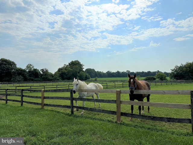 view of yard featuring an enclosed area and a rural view