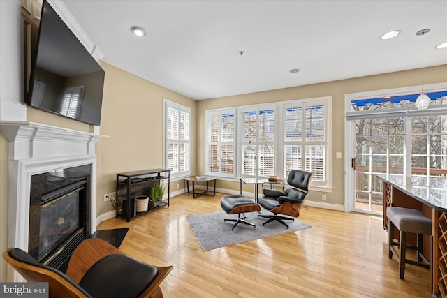 sitting room with recessed lighting, baseboards, light wood-style floors, and a fireplace