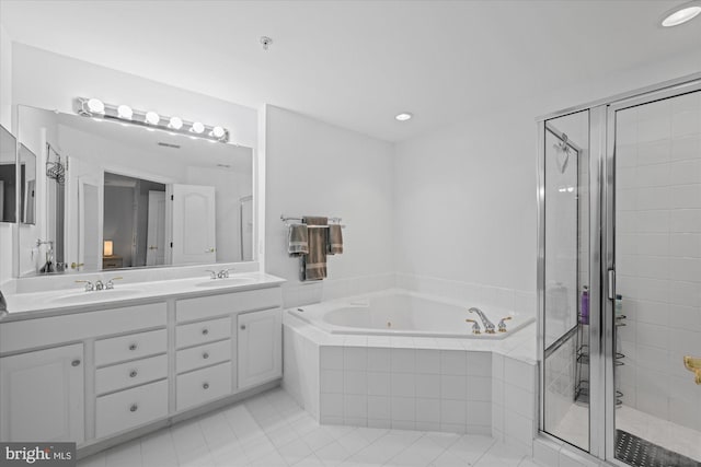 full bath with double vanity, a whirlpool tub, a shower stall, and a sink